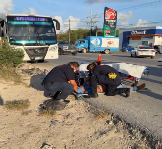 Bicycle and bus meet on a section of busy Tulum highway