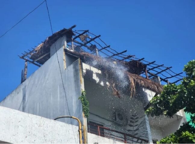 Tulum firefighters extinguish burning palapa on building rooftop