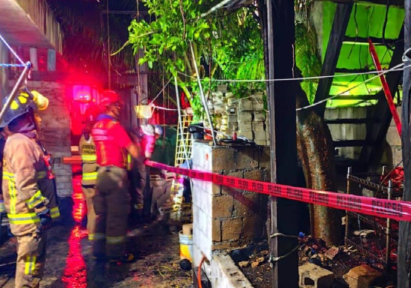 Burning palm tree leaves home below in partial ruins