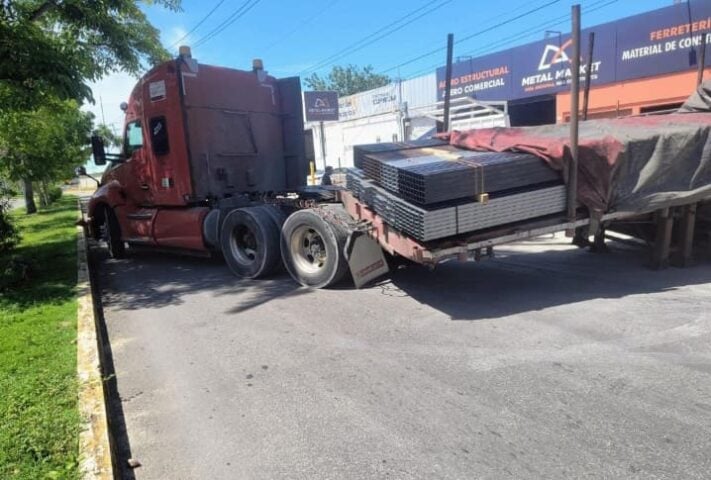 Semi bed loaded with steel breaks free blocking busy avenue