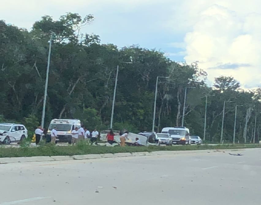Paramedics attend to injured driver in Tulum airport road rollover