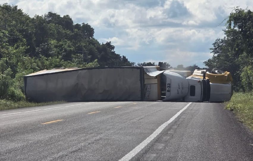 Semi lands on its side taking sharp corner closing federal highway traffic in both directions